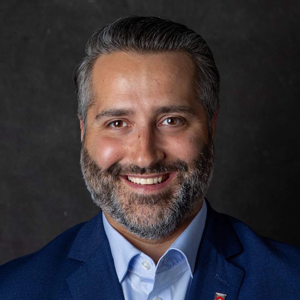 Professional headshot of Jon Bragg, First Vice President — Private Banking for Paragon Bank. Bragg is in a blue suit, blue shirt against a neutral background.